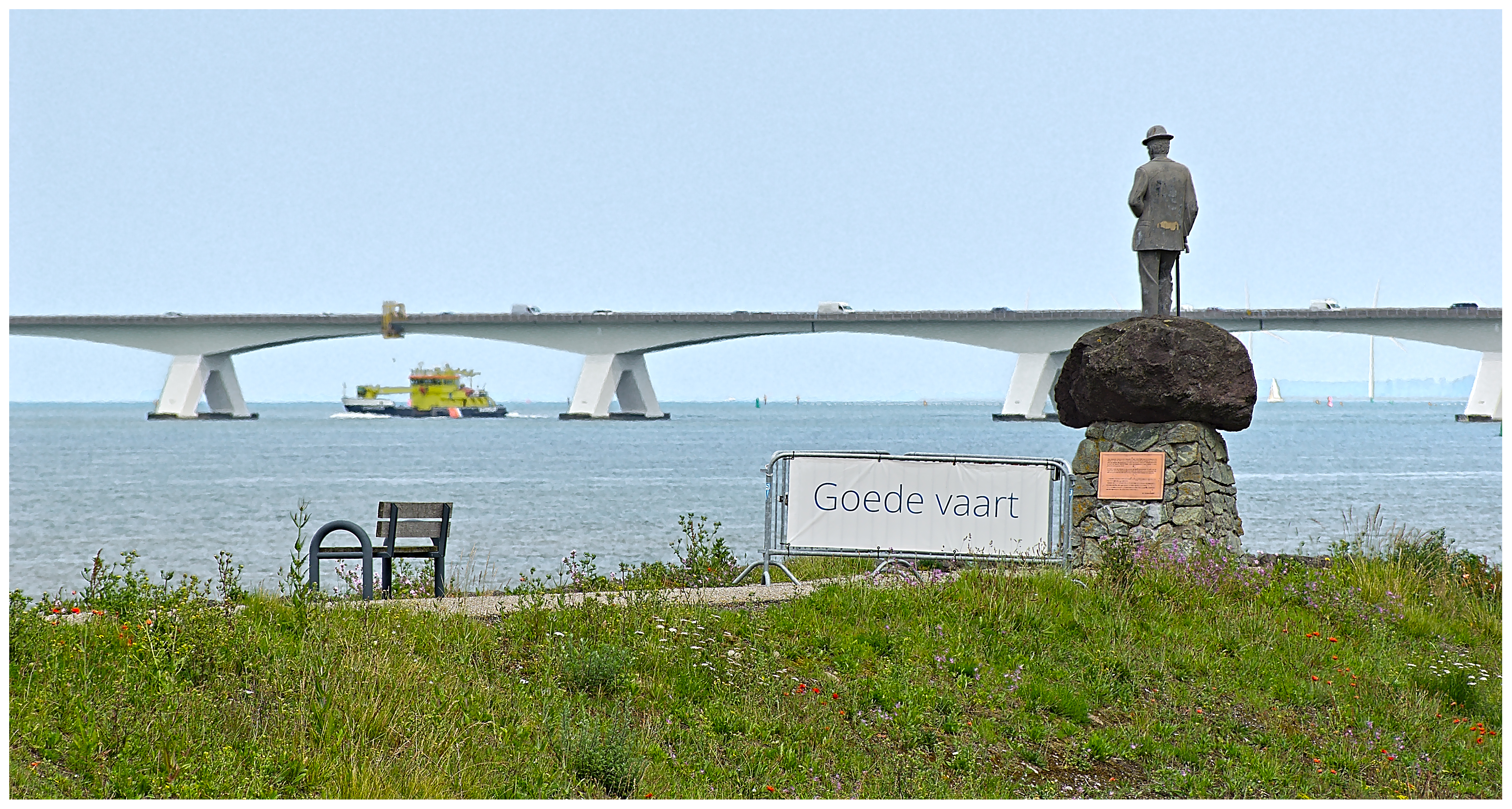 Uitzicht vanaf Colijnsplaat op de Oosterschelde. Het monument op de voorgrond "herdenkt Johannis de Rijke (1842-1913), geboren in Colijnsplaat, die dertig jaar in Japan werkte. Hij [...] paste zijn vakkennis en praktische ervaring met Nederlandse waterwerken toe bij de aanleg en verbetering van havens, grachten, dijken en waterfronten in Japan [...]". (afkomstig van de roodachtige plaat op het sokkel).
Op de achtergrond de Oosterschelde, de Zeelandbrug en de "Vliestroom" (Nederlandse Kustwacht).
View from Colijnsplaat on the Oosterschelde. The monument in the foreground "commemorates Johannis de Rijke (1842-1913), born in Colijnsplaat, who worked in Japan for thirty years. [ ... ] He [ ... ] applied his professional knowledge and practical experience of Dutch waterworks to build and improve harbours, canals, dikes, and waterfronts in Japan [...]". (taken from the reddish plate on the base).
In the background the Oosterschelde, the Zeelandbrug, and  the "Vliestroom" of the Netherlands Coastguard.
Blick von Colijnsplaat auf die Oosterschelde. Das Denkmal im Vordergrund "erinnert an Johannis de Rijke (1842-1913), geboren in Colijnsplaat, der dreißig Jahre lang in Japan tätig war. [ ...] Er [ ...] setzte sein professionelles Wissen und seine praktische Erfahrung mit niederländischen Wasserbauwerken ein, um Häfen, Kanäle, Deiche und Hafenanlagen in Japan zu bauen und zu verbessern [...]". (entnommen von der rötlichen Platte auf dem Sockel).
Im Hintergrund die Oosterschelde, die Zeelandbrug und die "Vliestroom" der Niederländischen Küstenwache.

(I started with the English text, because the plate on the base is in English as well. Translation to Dutch and German by Deepl.com + a few manual changes).